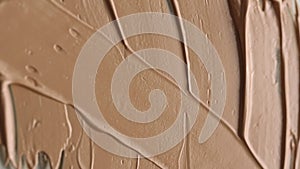 Vertical video. Macro video shooting of cosmetic cream. Beige texture. View from above