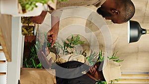 Vertical Video Male client paying for nonpolluting pantry supplies at market