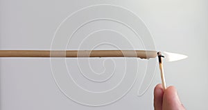 Vertical video. A man`s hand lights a single candle with a match