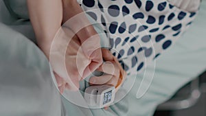 vertical video: Mother holding daughter hands waiting for medication treatment after sickness infection