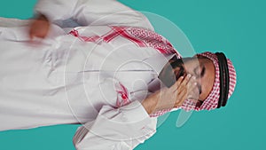 Vertical video Sleep deprived guy yawning in studio