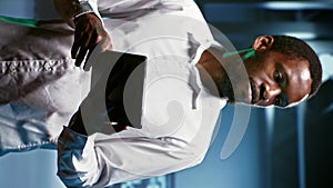 Vertical video Technician doing checkup in server room