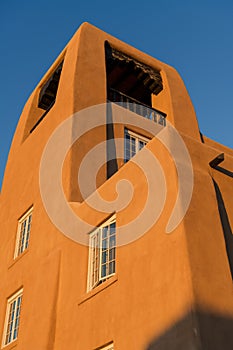 Vertical view of an adobe building and tower in Santa Fe, New Mexico
