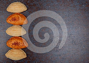 vertical view of azeri traditional bakery products as shakarbura and badambura on black and maroon background with copy space