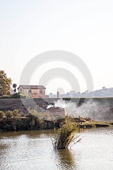 Vertical view of a brickmaker working on a riverbank in Madagascar