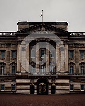 Vertical view of Buckingham Palace entrance exterior on a rainy day