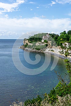 Vertical view of the church at Hojerup on top of the white chalkstone cliffs of Stevns Klint photo