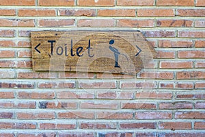 Vertical view of classic simple design handmade wooden sign of toilet give direction to WC , island Bali, Indonesia