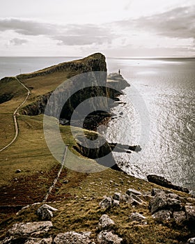 Vertical view of the coastline cliff of the sea under the cloudy sky before the storm