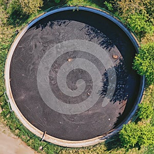 Vertical view down to a large circular tank for the storage of liquid manure