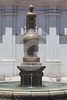 Vertical view of a fountain in front of the La Moneda Palace in Santiago, Chile photo