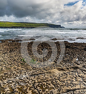 Vertical view of the glaciokarst coastline at Doolin Harbor with the Cliffs of Moher in the background