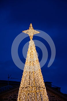 Vertical view of the illuminated Christmas tree and star of the decoration of Puebla de Sanabria