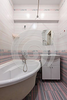 Vertical view of the interior of an ordinary habitable bathroom in the interior of a hotel room photo