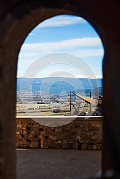 Vertical view of Luberon valley in Vaucluse, Provence, France across stone arch in one of the most beautiful villages of France