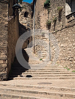 Vertical view of the medieval Sant-Domenec steps under the sunlight photo