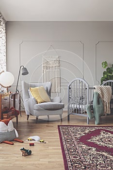 Vertical view of mid century baby room with patterned bedding