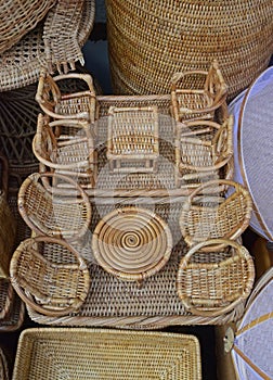 Vertical view of Miniature Rattan Set of different Coffee Table and comfortable chairs
