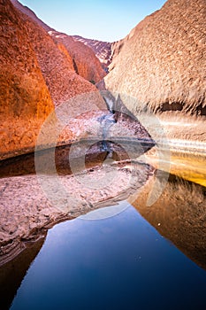 Vertical view of the Mutitjulu waterhole on summer time with clear sky in NT outback Australia photo