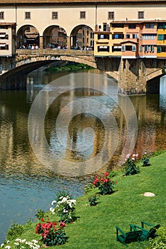 A vertical view of Ponte Vecchio and the Arno river on a beautiful sunny spring day in Florence, Italy. Popular medieval bridge