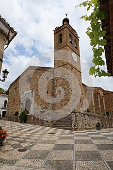 Vertical view of the Puerta del perdon and bell tower of the church of San Martin in Almonaster la Real, Huelva, Spain photo