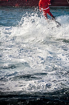 Vertical View of Santa Claus on Flyboard on Blur Background