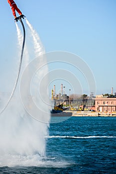 Vertical View of Santa Claus on Flyboard on Blur Background