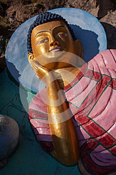 Vertical view of statue showing Sleeping lion`s posture or Reclining Buddha.