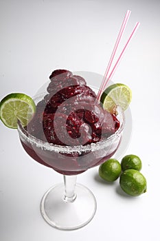 Vertical view of a strawberry smoothie with limes isolated white background