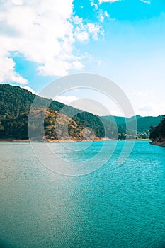 Vertical view of Sunnet Lake, clean water and blue sky, Mountain Forests at the far end, Bolu, Turkey