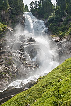 Vertical view of a tall waterfall in the austrian Alps