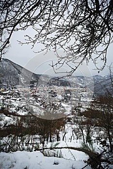 Vertical View of the town of Terranova di Pollino in Winter, Covered with Snow photo