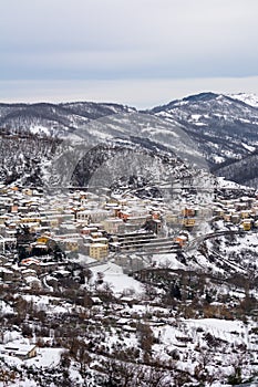 Vertical View of the town of Terranova di Pollino in Winter, Covered with Snow photo