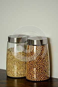 Vertical view of two clear glass food storage Canisters placed beside each other