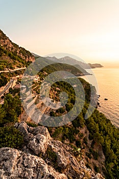 Vertical views of the north coast of Mallorca with the Sierra de Tramuntana and the Mediterranean Sea near BaÃÂ±albufar at sunset photo