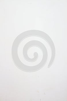 Vertical white background of a white textured wall with unevenness and plaster