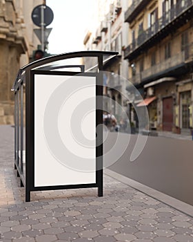 A vertical white blank billboard mockup at a bus stop on a city street. Bus stop billboard mockup