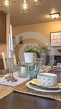 Vertical White chairs around a brown dining table with hemp table runners and placemats