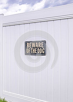 Vertical White vinyl fence gate with two beware of dog the signages