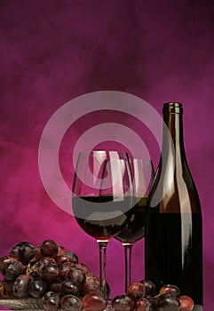 Vertical of Wine bottle with glasses and grapes