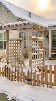 Vertical Winter home with pergola on the wooden gate