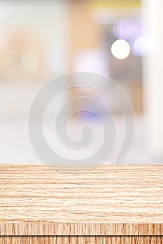 Vertical wood table background and blur background, Empty wooden counter, shelf surface over blur restaurant with bokeh background