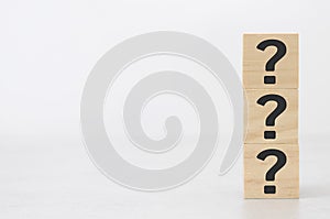 Vertical wooden block in question mark mean what on cement table black background business teamwork concept