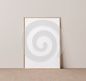 Vertical wooden frame mock up. Wooden frame poster on beige floor with beige wall background.