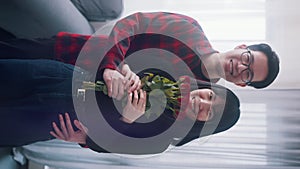 Vertical. Young asian man giving red roses to his girlfriend. Love romance and proposal