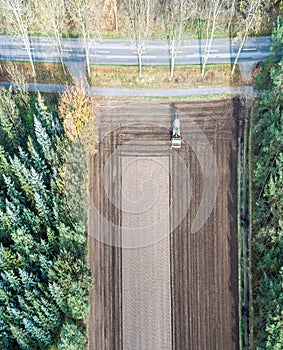 Vertically aligned aerial photograph of a field area worked by a