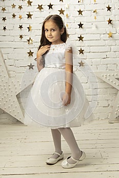 Vertically elegant child in a white dress