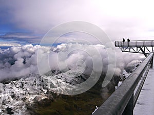 Vertiginous view of the pontoon of the sky at the peak of the Midi of the Pyrenees under the snow