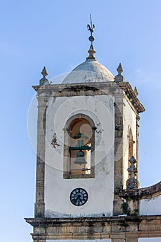Vertival shot of the Santa Rita de Cassia church's bel, the old buildings in Paraty, Brazil