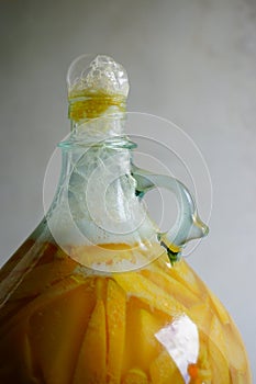 Very active fermentation of organic peach wine or mead in a glass carboy